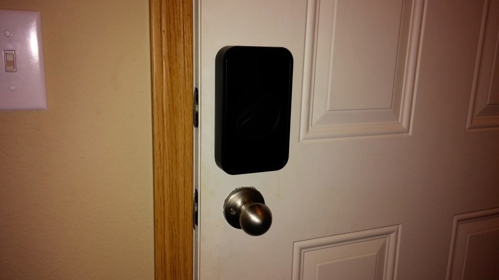 A closeup picture of the Lockitron installed on the door.  It's  a bit hard to see, but it gives you an idea of the size of the device!  It's much larger than I originally thought it'd be.